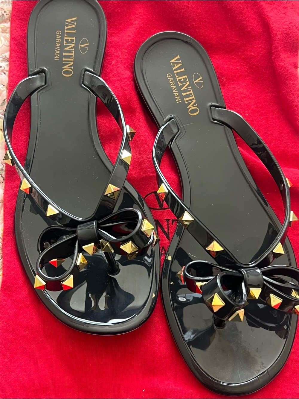 Valentino Garavani Black Jelly Flip Sandals with Gold Pyramid Studs and Bows